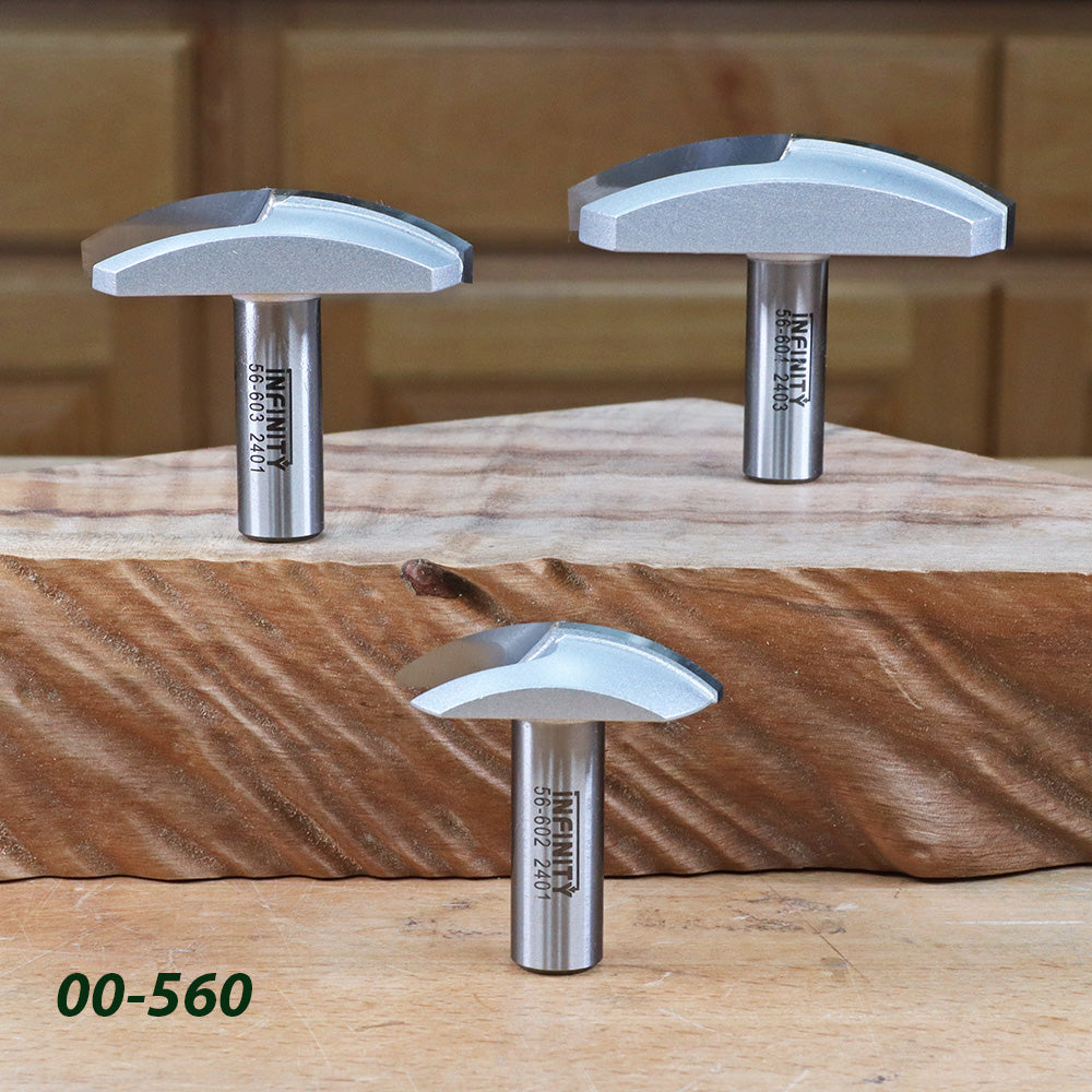Three roundover router bits displayed on a wooden block in a woodworking shop setting