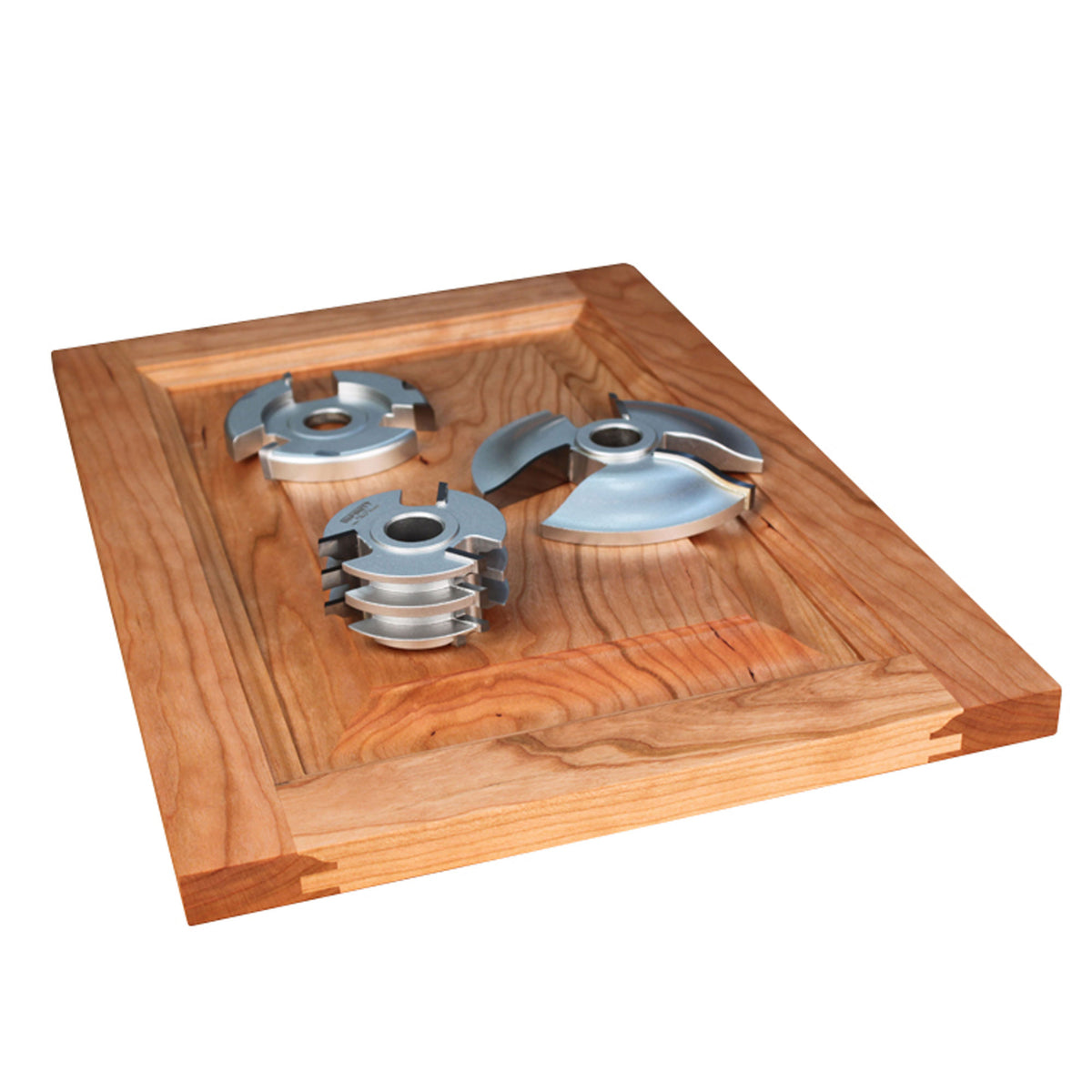 A 3-pc. shaper cutter set for cabinet doors positioned on a finished cabinet door on a white background.