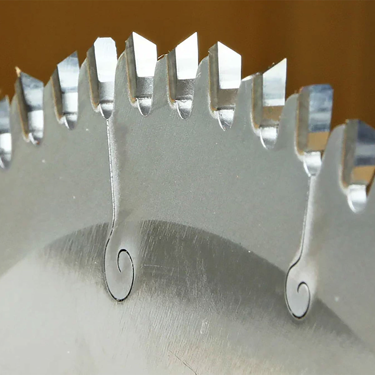 Close-up of carbide-tipped circular saw blade teeth for woodworking precision cuts