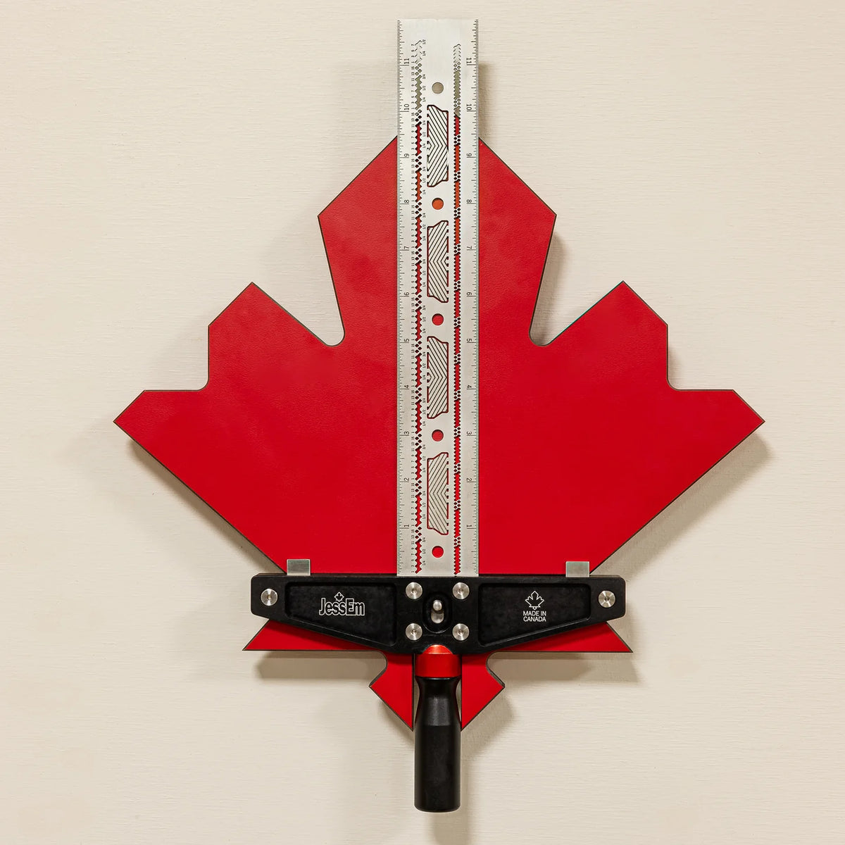 Precision woodworking router table fence tool with red maple leaf backplate and ruler guide