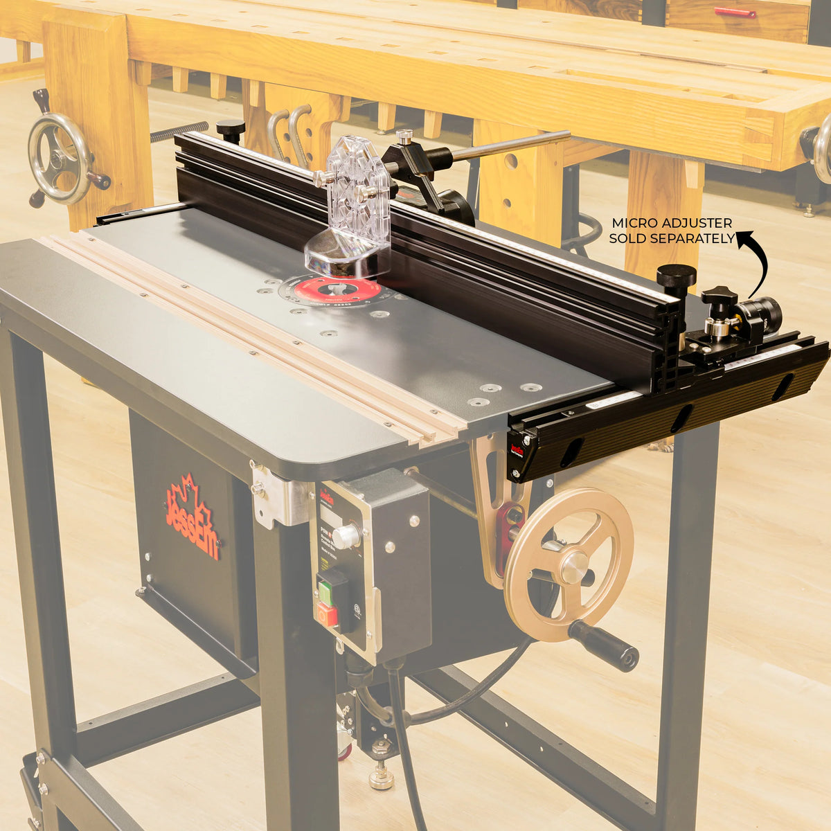 Router table with adjustable fence and clear guard in a woodworking shop setting