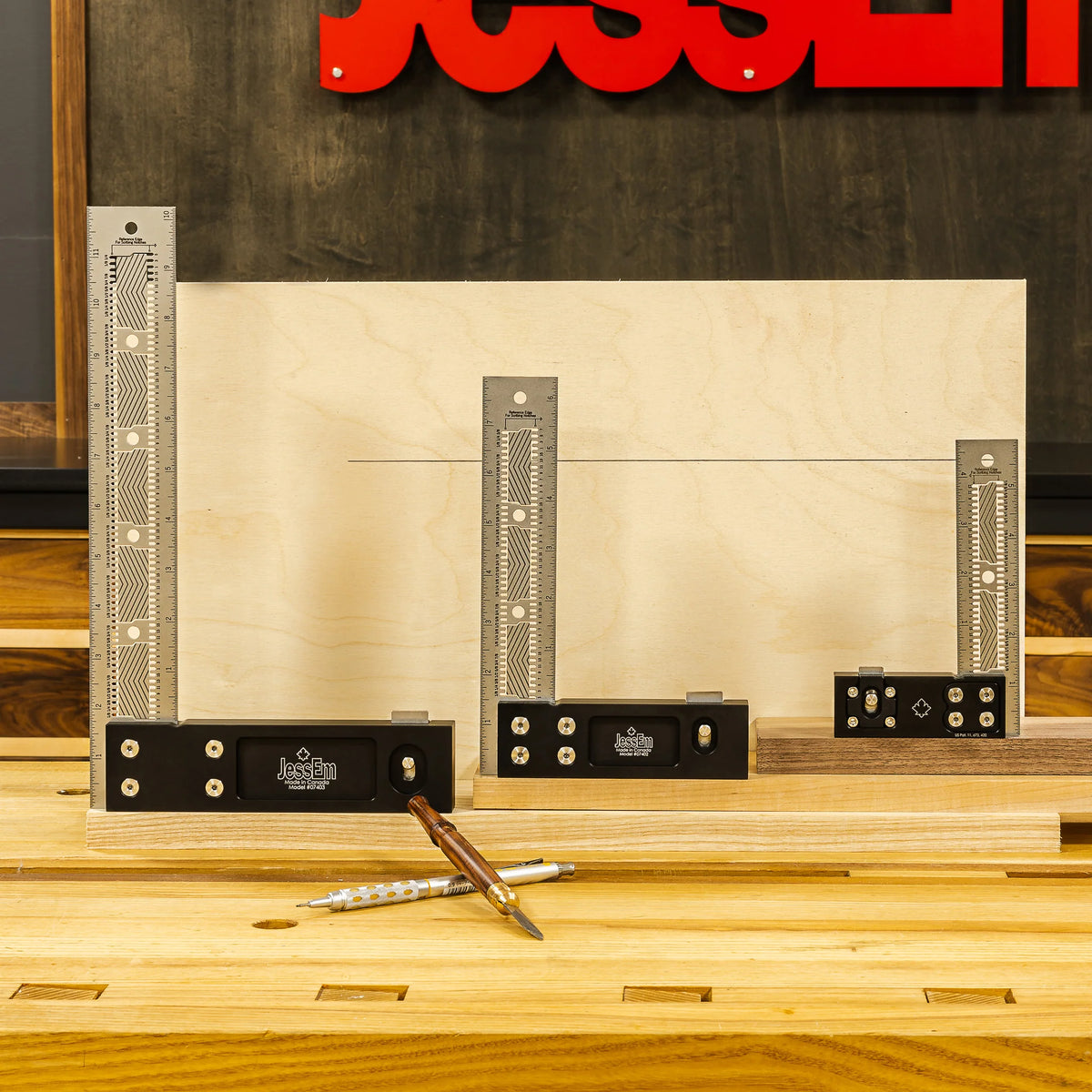 Set of precision woodworking squares and marking tools on a workbench with wooden boards
