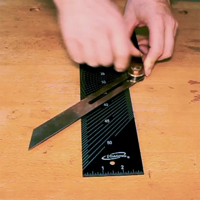Setting a metal bevel gauge on an angle ruler for precise woodworking measurement