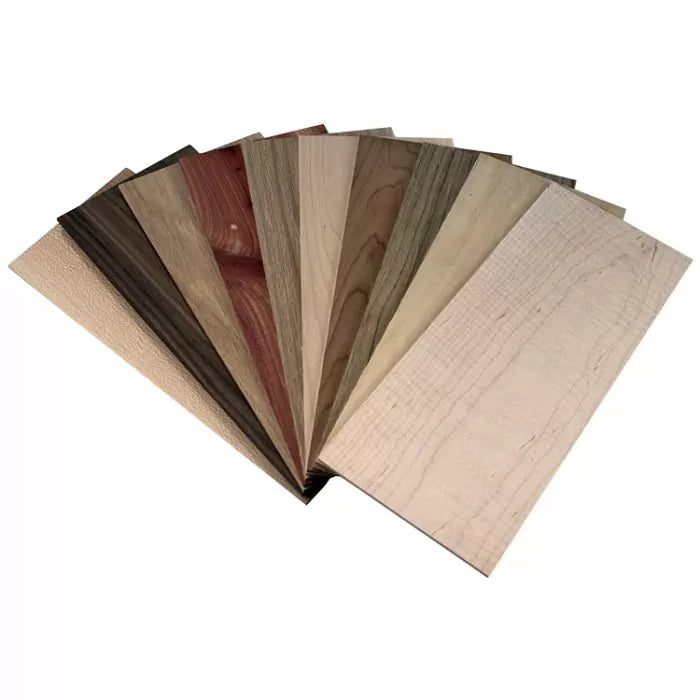 Assorted wood veneer sheets fanned out, showcasing different woodworking materials.