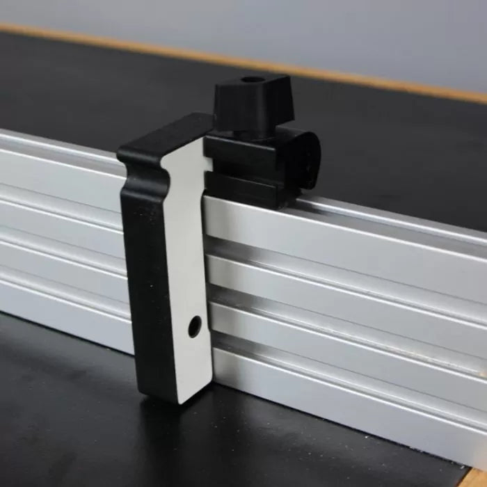 Aluminum router fence with black plastic stop block for woodworking precision.