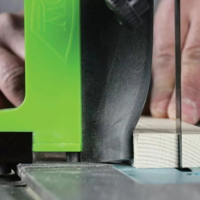 Close-up of band saw cutting wood with push block for woodworking safety