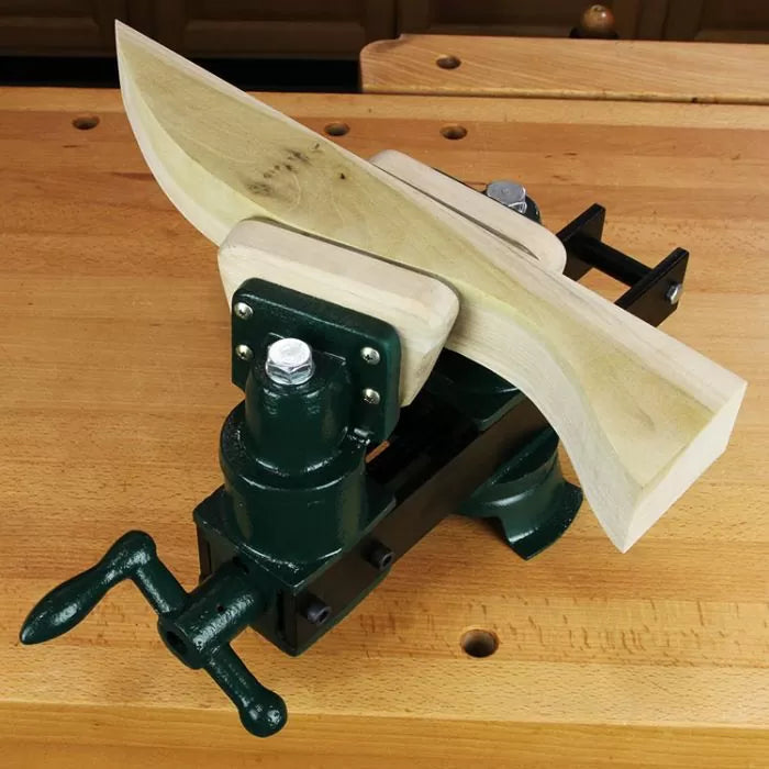 Woodworking vise securely clamping a curved wood piece on a workbench
