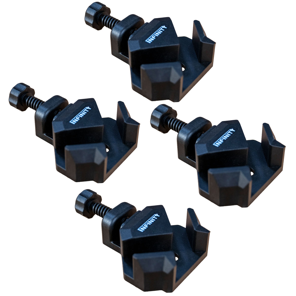 Set of four black corner clamps for woodworking on a white background