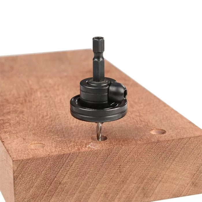 Self-centering drill bit guide on wood block with pre-drilled holes for woodworking