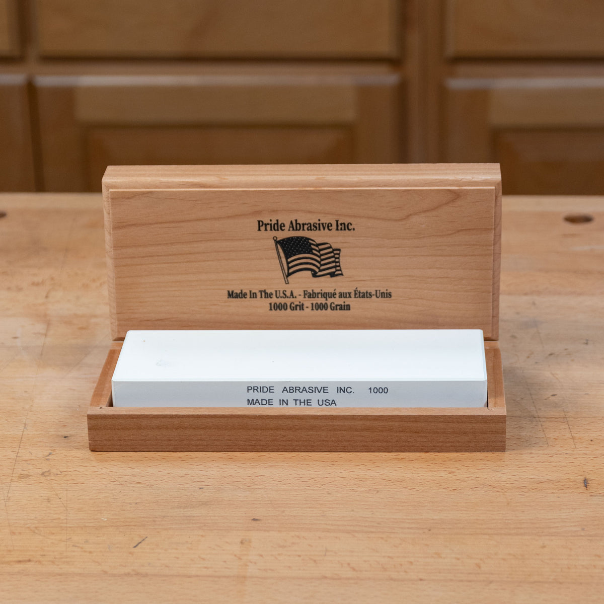 1000 grit sharpening stone in wooden box on workbench, ideal for woodworking tools