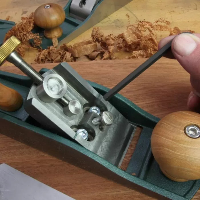 Adjusting frog screws on a hand plane woodworking tool with Allen wrench