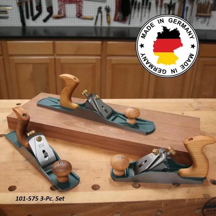 Three wood hand planes with wooden handles on a workbench in a woodworking shop, made in Germany.