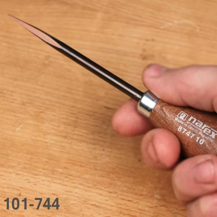 Woodworking marking awl with wooden handle held in hand on a workbench