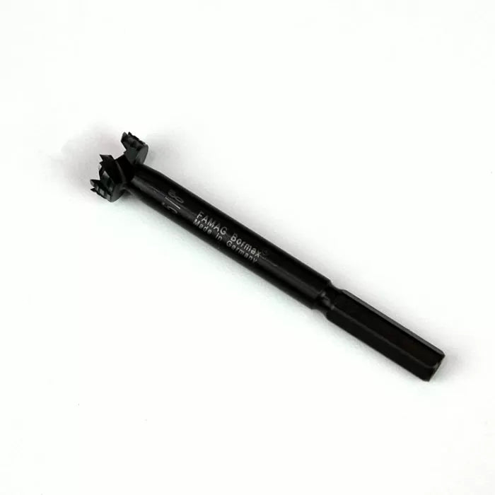 Black woodworking Forstner drill bit with hex shank on white background