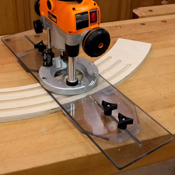 Woodworking router with clear straight edge guide cutting curved slots in plywood