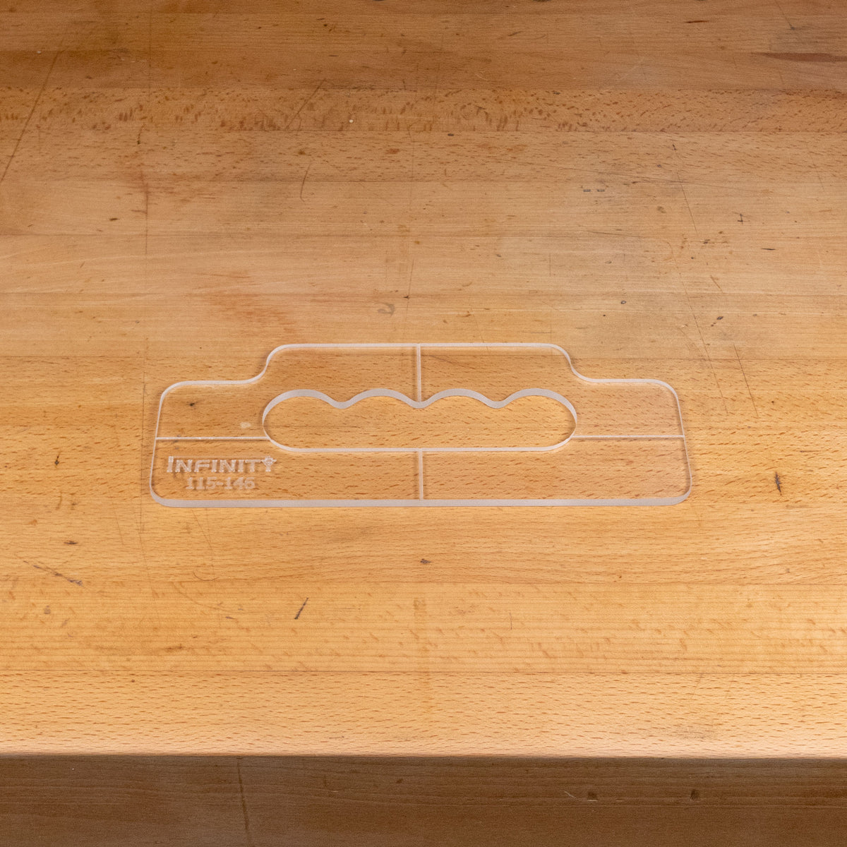 Clear acrylic handle template for woodworking on a wooden workbench