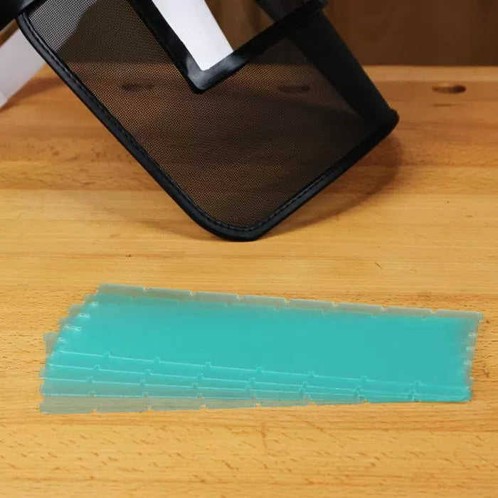 Stack of turquoise featherboard replacement fingers on a wood surface under face shield