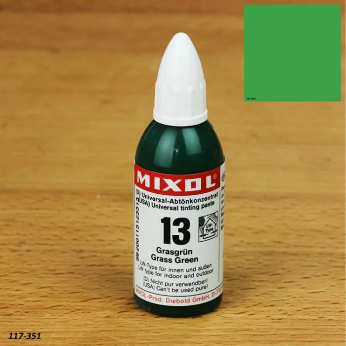 Mixol universal tinting paste bottle, grass green color, on wood surface