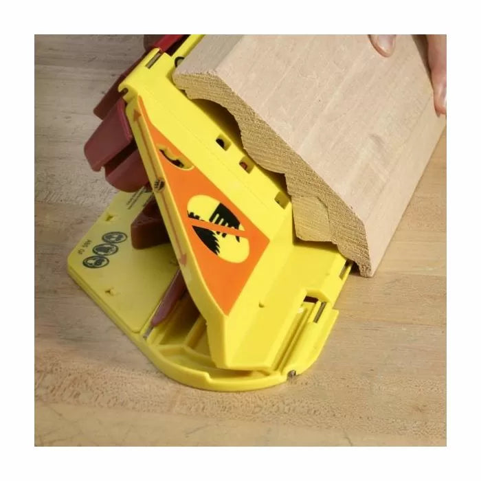 Woodworking push block gripping large molding on workbench for safe cutting