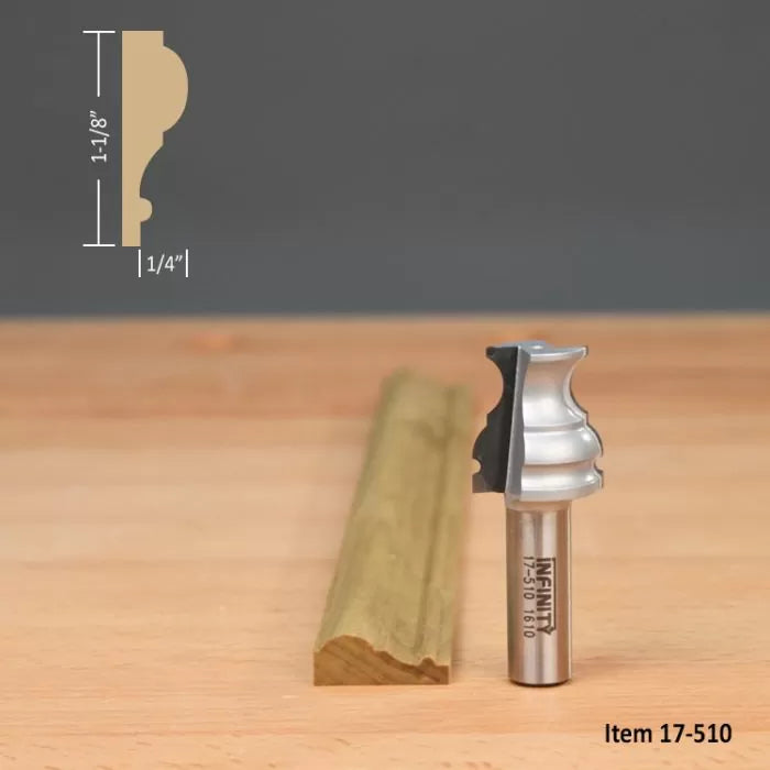 Ogee router bit with sample molding profile and dimensions on wood surface.