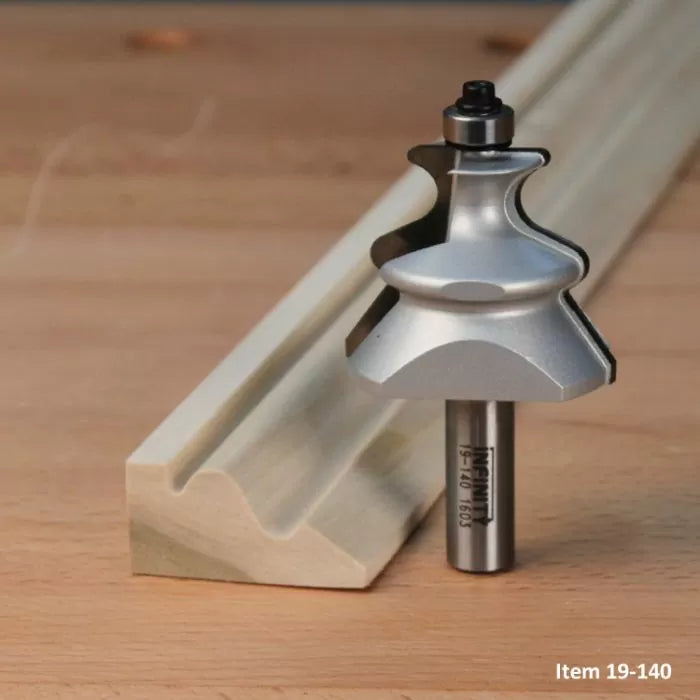 Woodworking router bit with matching decorative edge profile on wood molding, on workbench