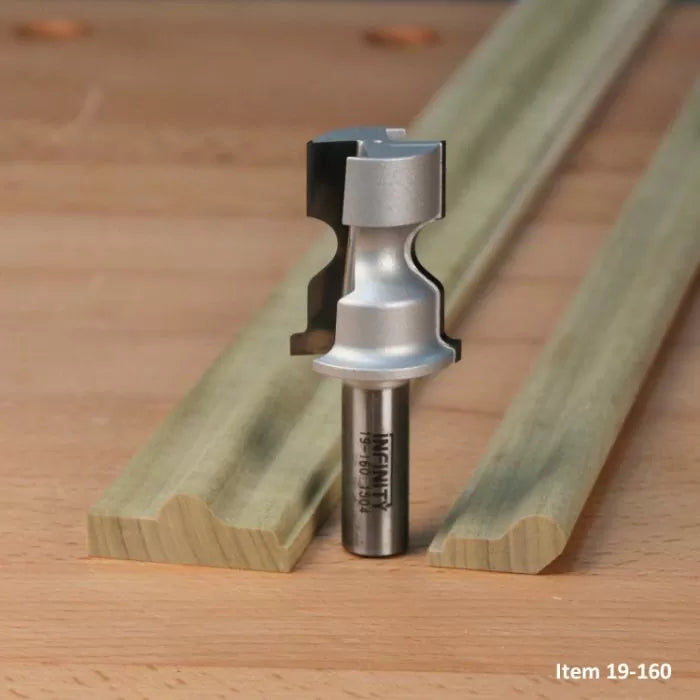 Router bit for woodworking, shown with two shaped moulding wood pieces on a workbench.