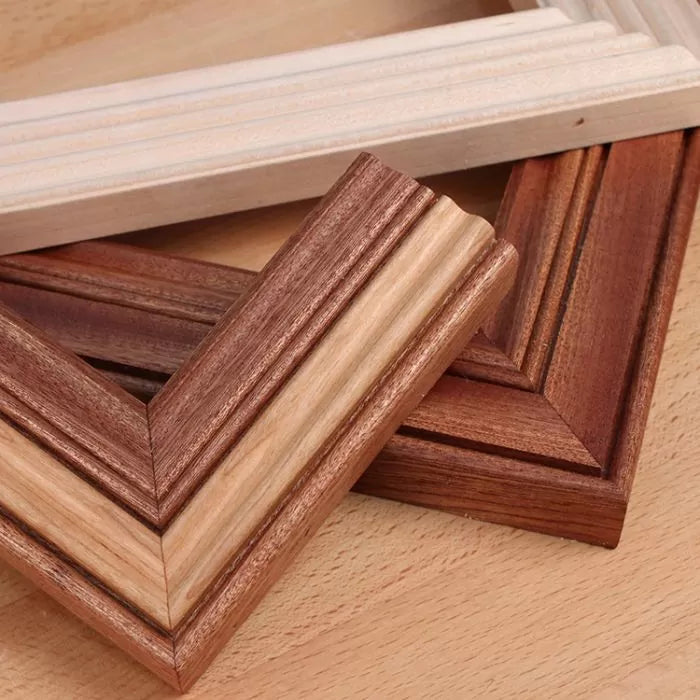 Assorted wooden picture frame corners showcasing detailed molding and woodworking joints.