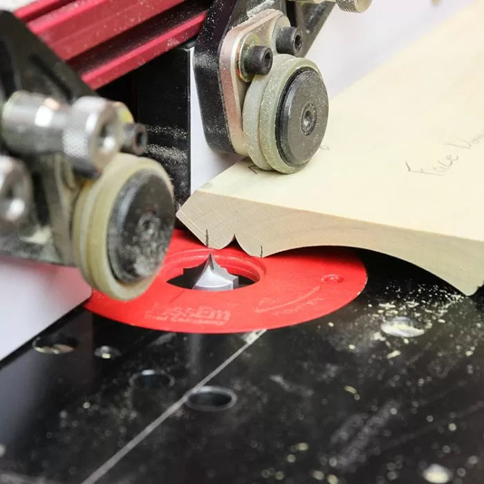 Router table setup cutting decorative edge on wood with precision woodworking bit