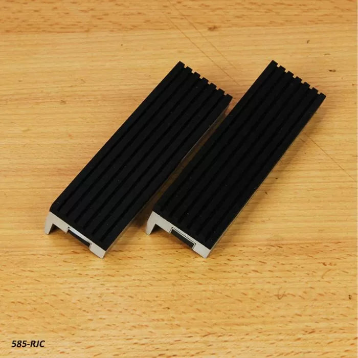 Pair of black rubber jaw covers for woodworking vise on a wooden surface