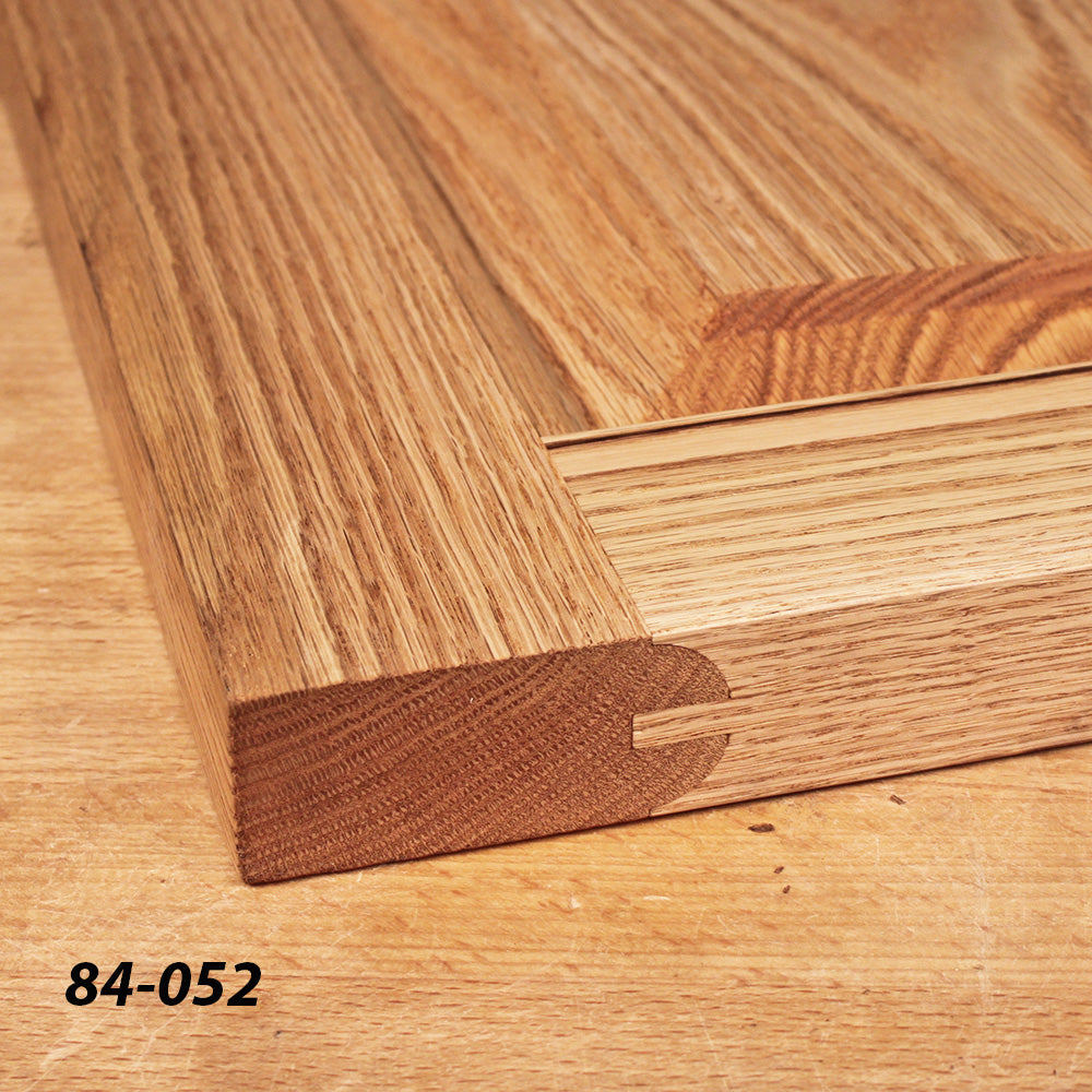 Close-up of a wooden door frame joint with dowel detail on a workbench, woodworking project.