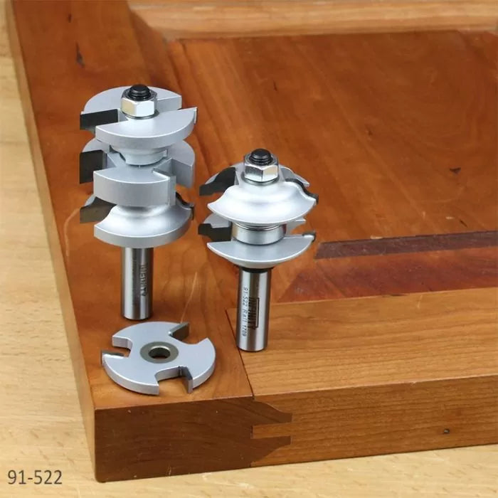 Carbide-tipped router bit set for cabinet door joinery on a wooden workbench