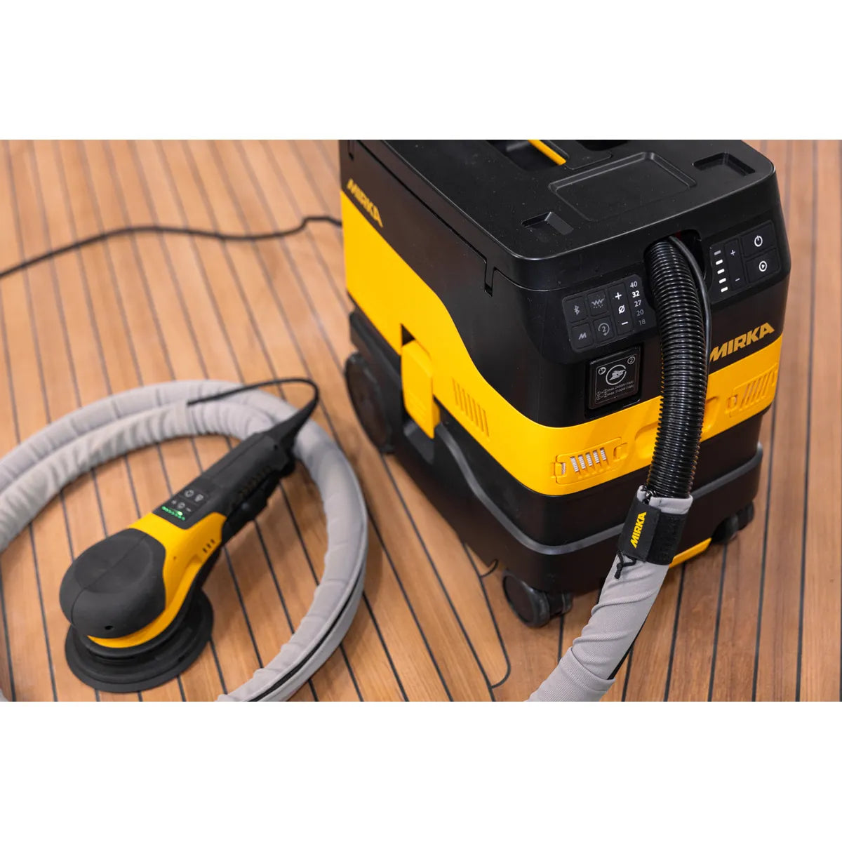 Mirka coaxial vacuum hose connected to a DEROS II sander in use