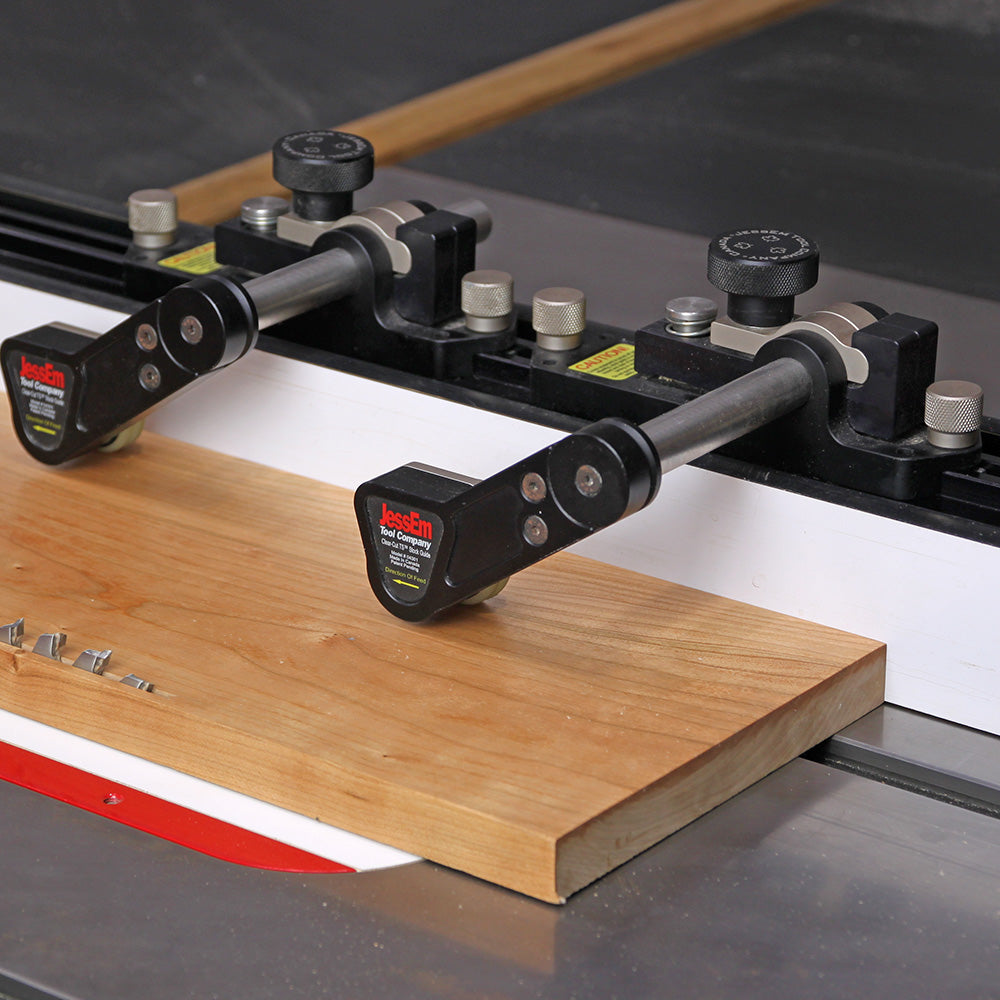 Table saw featherboard hold-downs securing wood for safe, precise woodworking cut