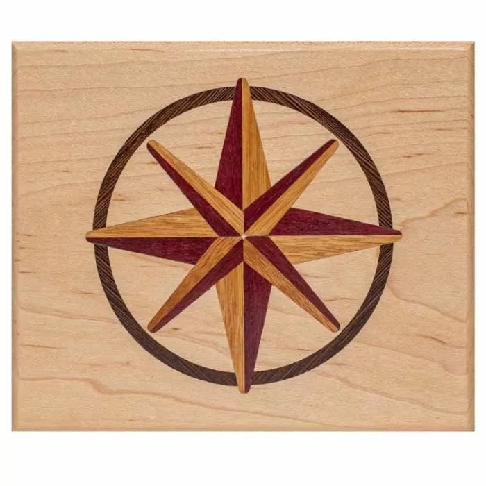 Wood inlay compass rose star design on light maple panel, ideal for woodworking projects