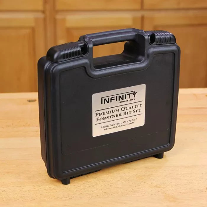 Black plastic case labeled Premium Quality Forstner Bit Set on a woodworking bench