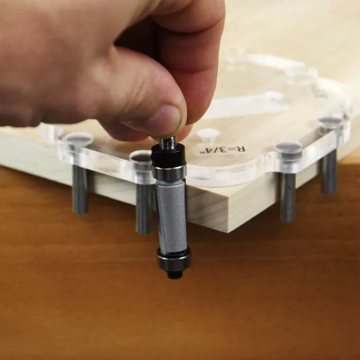 Hand installing woodworking router jig guide on wood corner for precise routing