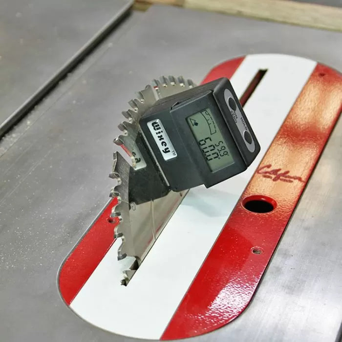 Digital angle gauge measuring table saw blade bevel angle on metal surface