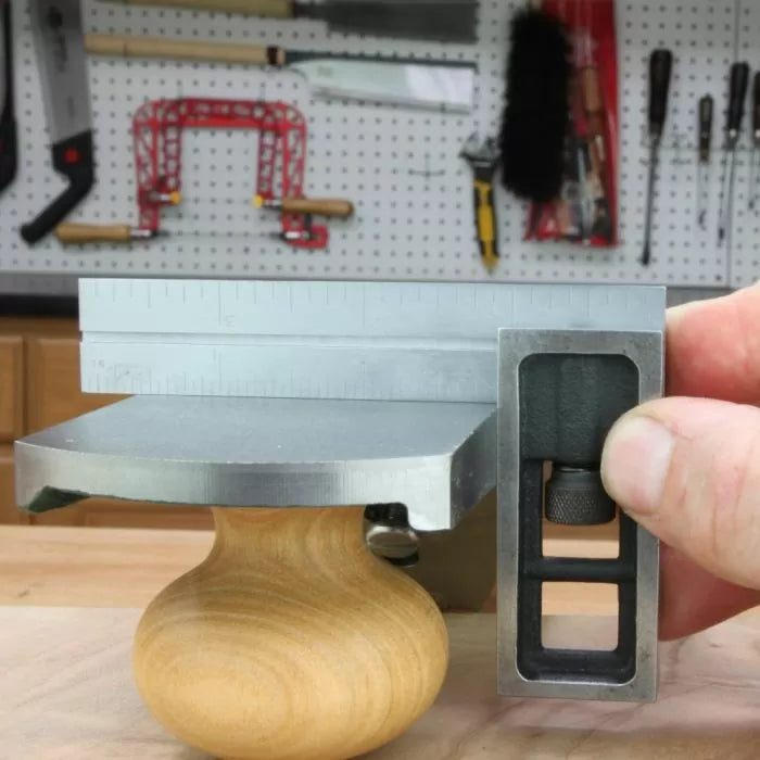 Checking hand plane sole flatness with a precision square on a woodworking bench