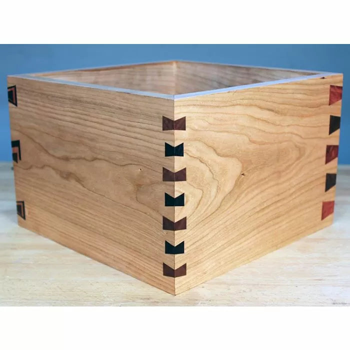 Square wooden box with decorative dovetail joints, ideal for woodworking projects.