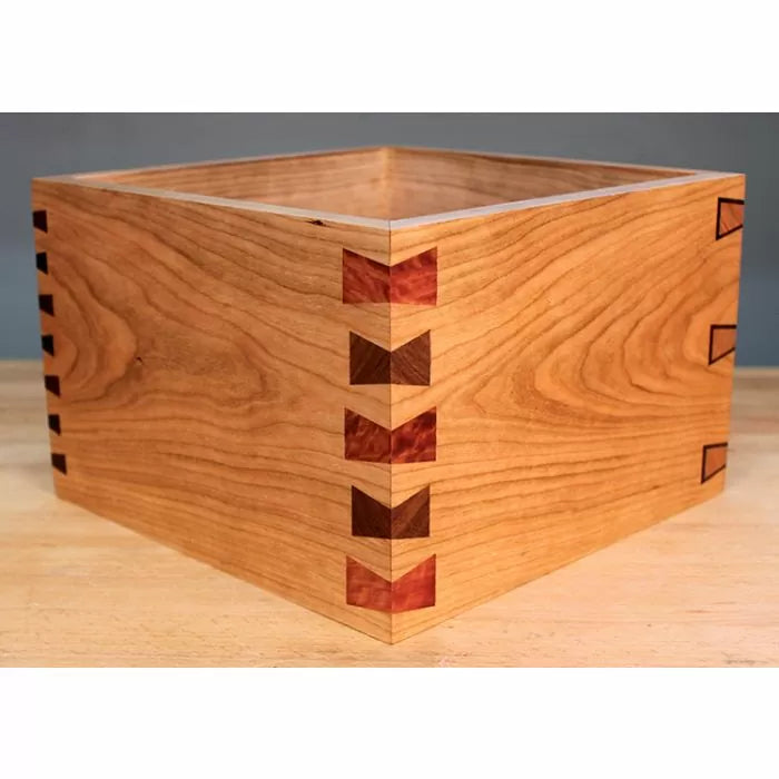 Wooden box with decorative dovetail and butterfly joints, showcasing fine woodworking craftsmanship.