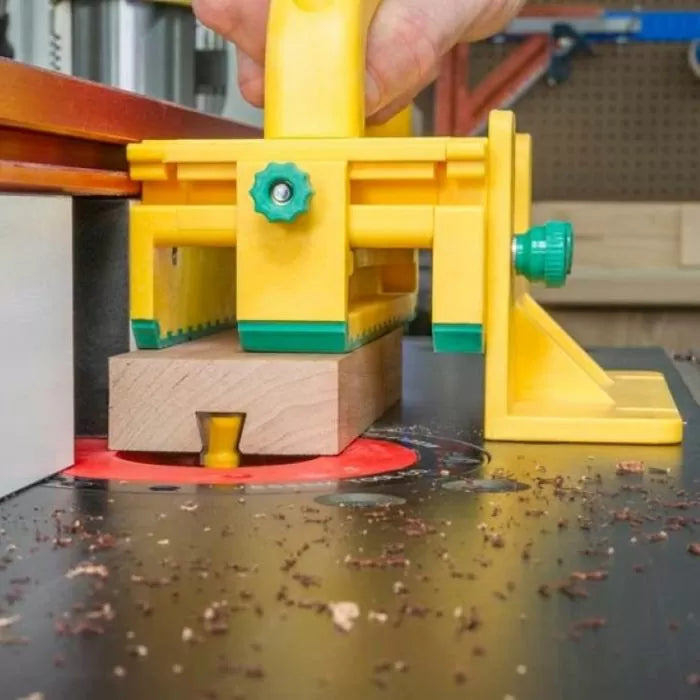 Router table setup with push block cutting dovetail joint in wood for precise woodworking