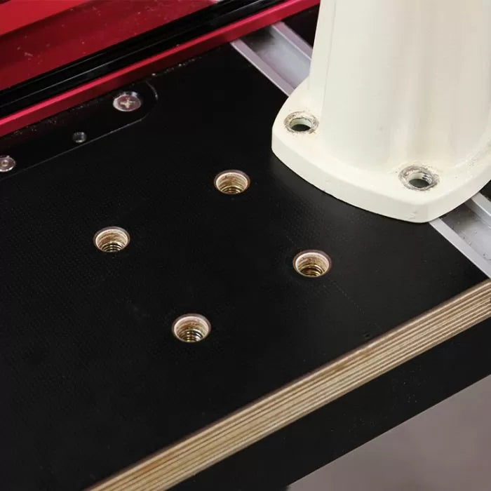 Router table top with inset threaded inserts and metal fence for woodworking tools