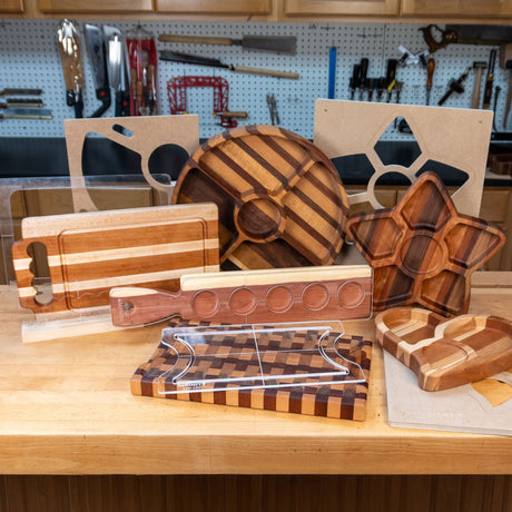 Wooden cutting boards and serving trays shown with clear acrylic routing templates