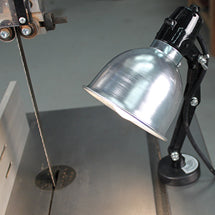 Magnetic base work light with aluminum shade mounted on a bandsaw