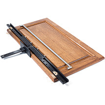 Cabinet hardware installation jig clamped to a wooden cabinet door