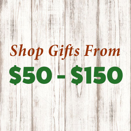 Shop Gifts From $50 - $150 text on a whitewashed wood plank background
