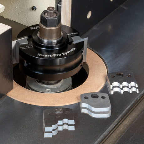 Infinity Insert-Pro shaper cutter head on a spindle with profile knife inserts