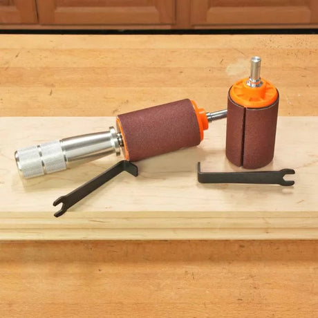 Two sanding drums with abrasive sleeves and spanner wrenches