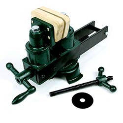 Green cast iron woodworking vise with wooden jaw pads and screw