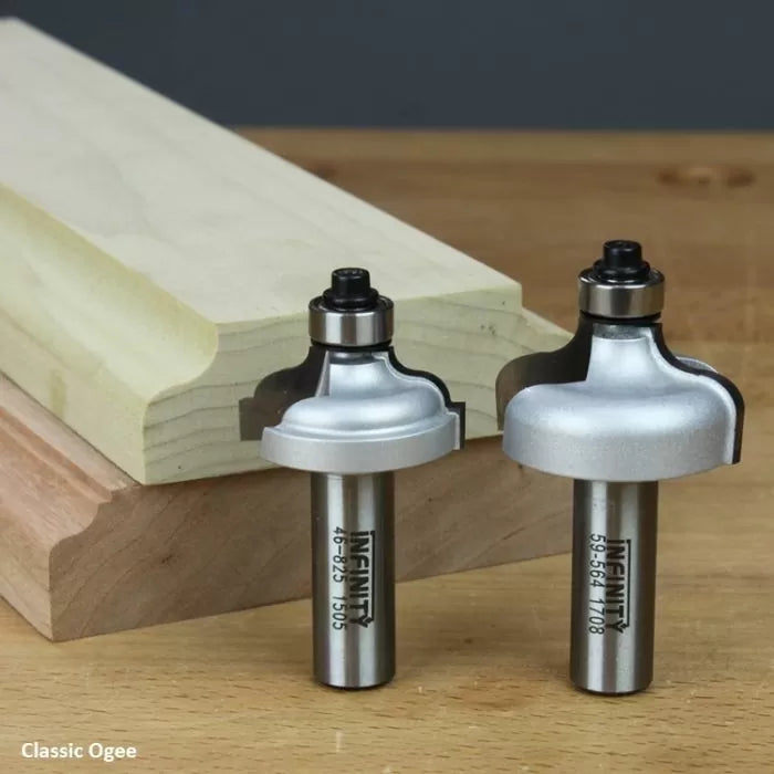 Classic ogee router bits for woodworking, shown with routed wood samples on a bench